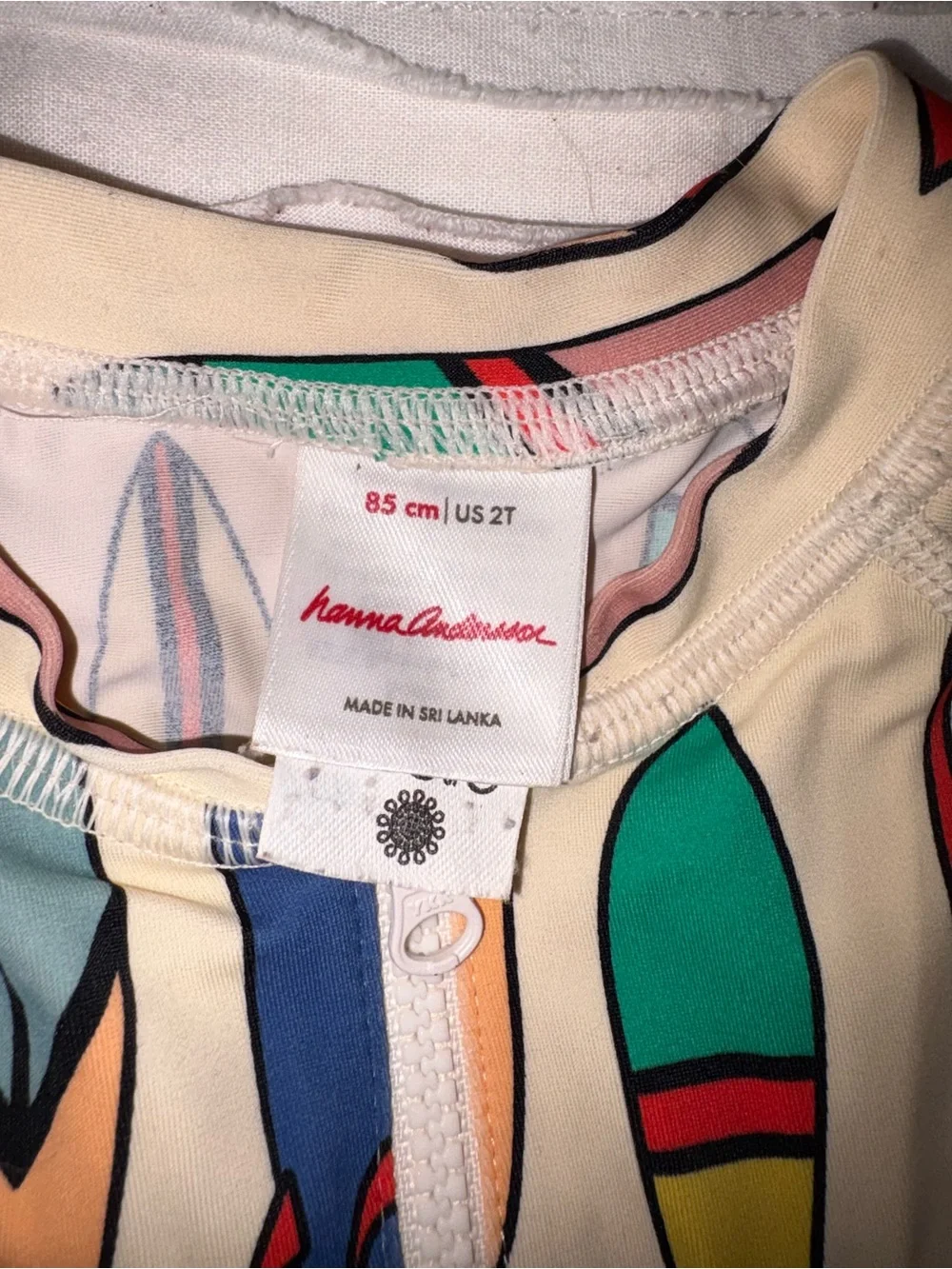 Hanna Andersson Cream Rashguard One-Piece with Colorful Surfboard Print